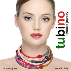 Model wearing multiple TUBINO MURANO linkable BRACELETS in array of fashion colors, luxurious hypoallergenic synthetic rubber with handmade murano glass links, easily cut to size, Made in Italy