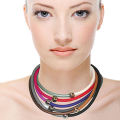 Model wearing multiple TUBINO SPORTIVO linkable BRACELETS in array of fashion colors, luxurious hypoallergenic synthetic rubber with nickel-free metal links, easily cut to size, Made in Italy