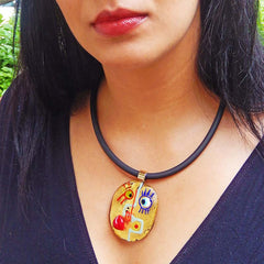 Model wearing CUBIST FACE 2 modern murano glass necklace, 24kt gold leaf pendant on black tubino, handmade in Italy