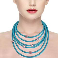 Model wearing multiple aqua TUBINO SPORTIVO linkable 18" NECKLACES,  luxurious hypoallergenic synthetic rubber with nickel-free metal links, easily cut to size.  Made in Italy