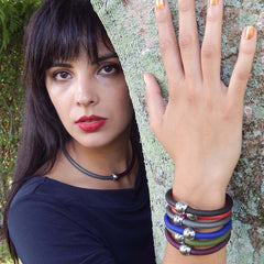 Model wearing multiple TUBINO SPORTIVO linkable fashion BRACELETS and necklace in array of colors, luxurious hypoallergenic synthetic rubber with nickel-free metal links, easily cut to size, Made in Italy
